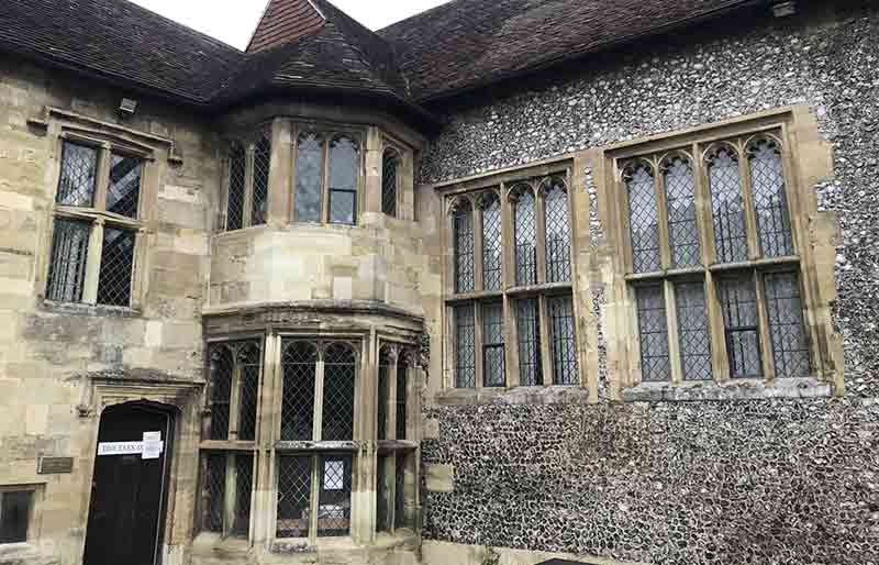 Stone and flint exterior of the building with leaded windows..