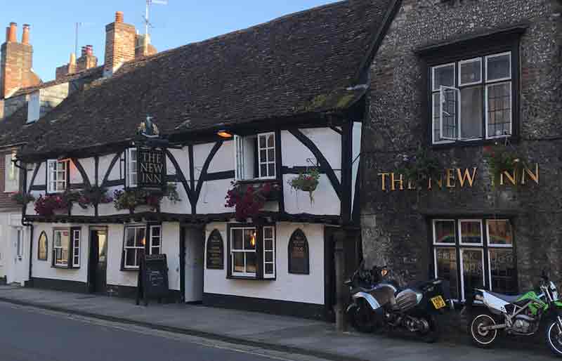 Timber framed facade of the pub with signage.